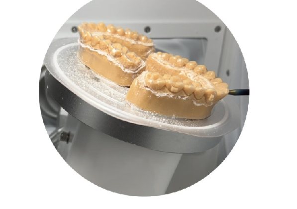 Two dental models held on the MaxTrim T2 turntable for dual-model trimming